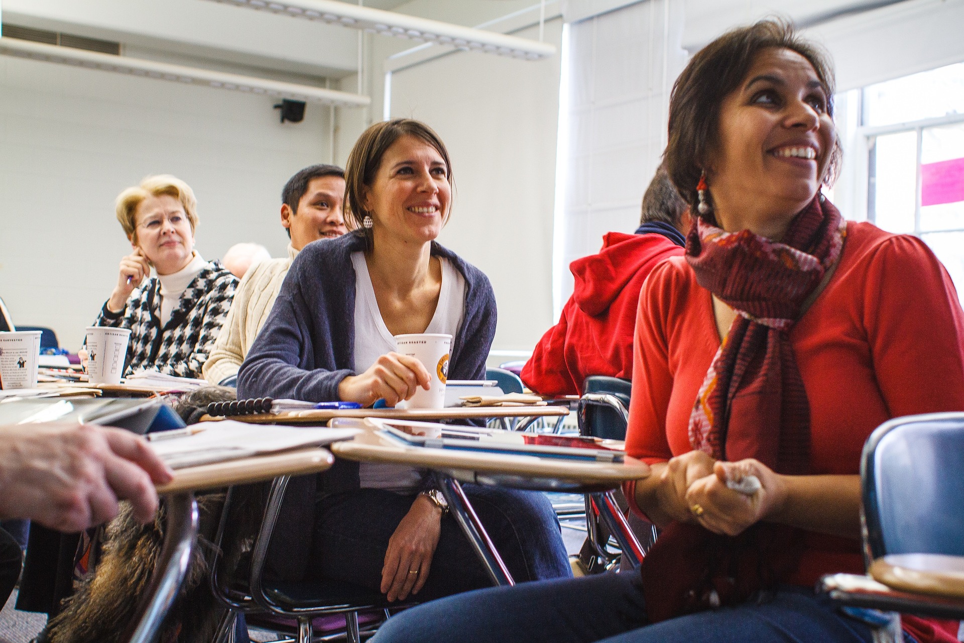 Educators smiling during a professional learning workshop